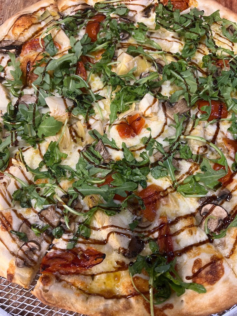 Artisan pizza with arugula and balsamic